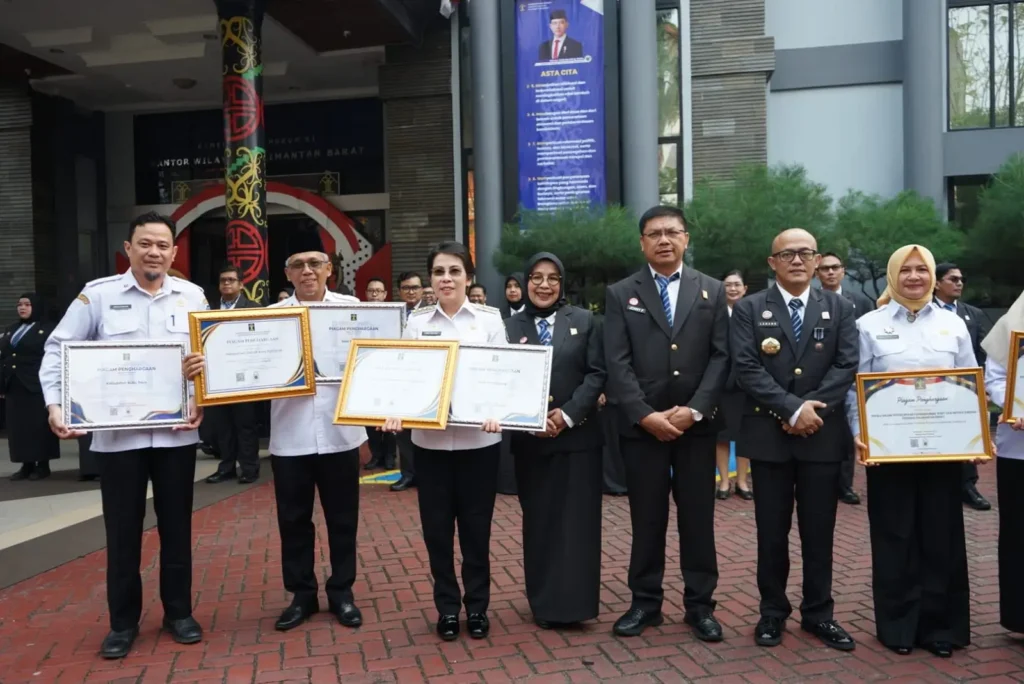 Kepala Kantor Wilayah Kemenkum Kalbar Jonny P Simamora menyerahkan penghargaan kepada Sekretaris Daerah Kota Pontianak Amirullah dalam rangkaian Upacara Hari Pengayoman di halaman Kanwil Kemenkum Kalbar, Rabu (19/8/2026).