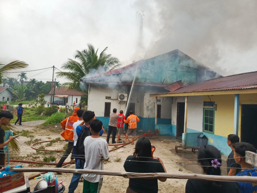 Petugas pemadam kebakaran memadamkan api yang menghanguskan rumah kost tiga pintu di Jalan Prawindo, Desa Paal, Nanga Pinoh, Kabupaten Melawi. (Foto: Res-Melawi)