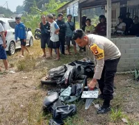 Petugas kepolisian melakukan olah TKP kecelakaan truk kontainer dan Honda Vario di Jalan Batang Tarang–Tayan Hulu, Kabupaten Sanggau, yang menewaskan pengendara motor.