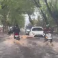 Genangan banjir merendam Jalan Perdana Pontianak akibat hujan deras dan air pasang Sungai Kapuas yang terjadi bersamaan.