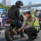 Ilustrasi razia knalpot brong di Pontianak dengan petugas Satlantas memeriksa sepeda motor pelanggar aturan lalu lintas.