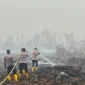 Personel Brimob melakukan pendinginan lahan gambut bekas terbakar di Rasau Jaya, Kubu Raya. (Res-KKR)