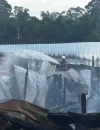Petugas pemadam kebakaran berupaya memadamkan api yang melahap rumah panjang di Kampung Labau, Sarawak menjelang perayaan Hari Gawai.