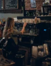 Coffee shop aesthetic Ilustrasi - Coffee shop aesthetic dengan interior minimalis, barista membuat manual brew, dan latte art kreatif sebagai tren ngopi 2025. (unsplash.com/@zdelo)